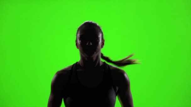 Athletic fitness woman running. Front view. Green screen. Slow motion — Stock video