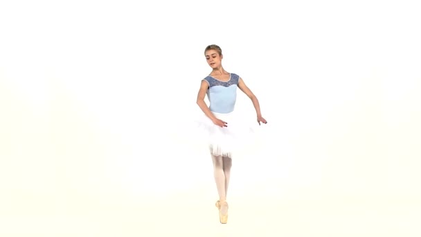 Portrait of the ballerina in ballet pose on white, slow motion — Stock video