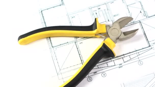 Cutting pliers on building plan, scheme, rotation — Stock Video