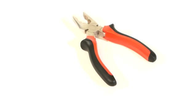 Gray and red pliers on white, rotation — Stock Video