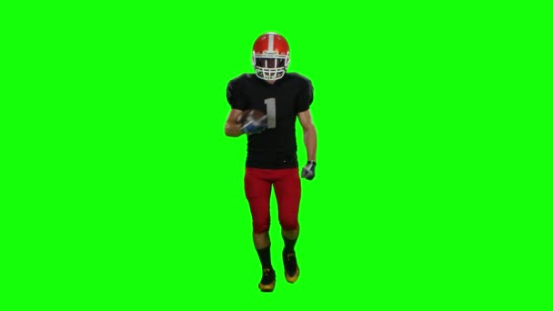 Přehrávač spuštěn v červená helma s míčem v rukou. Čelní pohled. Zelená obrazovka — Stock video