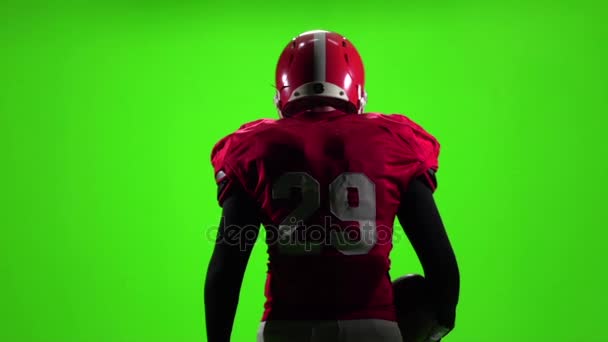 Football player with the ball is in the hands of. Slow motion. Green screen. Back view — Stock Video