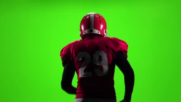 Football player touches the ball in his hand. Slow motion. Green screen — Stock Video