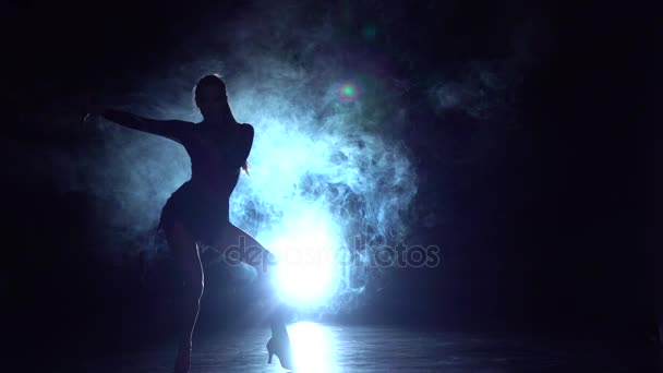 Девушка танцует латинский танец в студии, силуэт. Медленное движение — стоковое видео