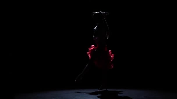 Girl dancing passionate latin dance, silhouette. Slow motion — Stock Video