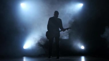 Adam yavaş şarkı gitar çalmaya. Duman stüdyo