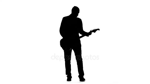 Musician plays a tranquil melody on the guitar. Silhouette. Studio — Stock Video