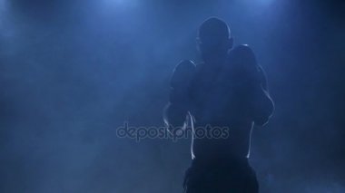 Sporcu boxer darbeler pratik hayali rakibin vurur. Ağır çekim