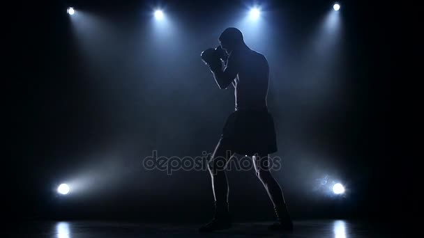 Training a blow boxer. Dark studio with spotlights — Stock Video