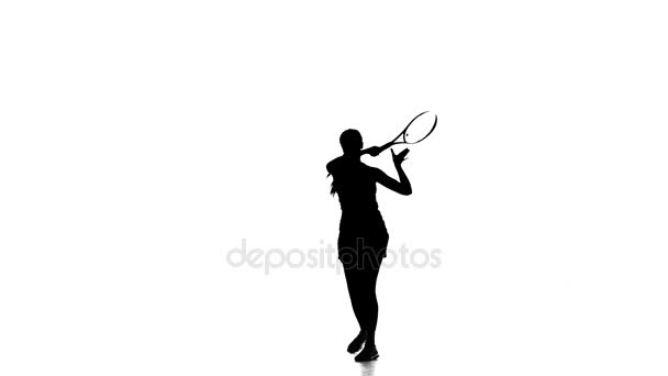 Girl with a racket in the hands of playing tennis. Silhouette — Stock Video