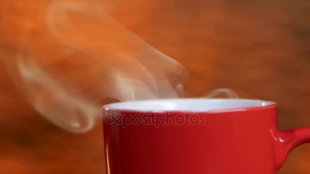 La taza roja refrescante del café perfumado difunde los olores agradables. Primer plano — Vídeo de stock