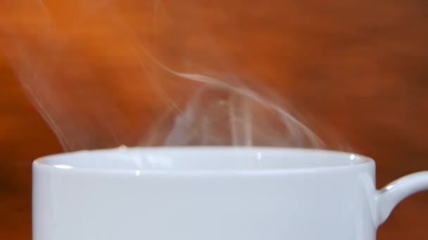 La taza blanca refrescante del café perfumado difunde los olores agradables. Primer plano — Vídeos de Stock