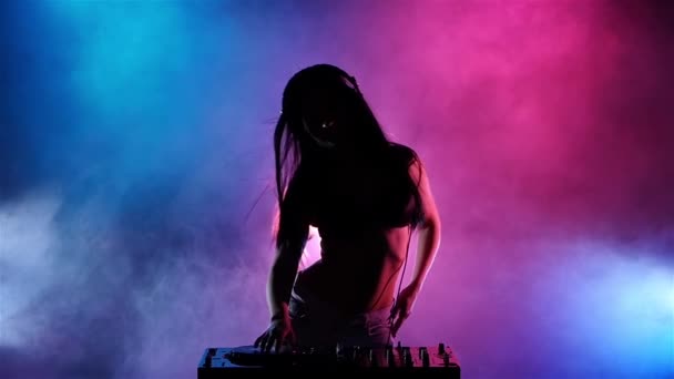 DJ fille avec écouteurs ses cheveux développe le vent. Au ralenti. Silhouette — Video