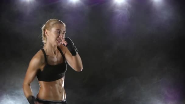 Woman boxer makes the punching and kicking. Close slow motion — Stock Video