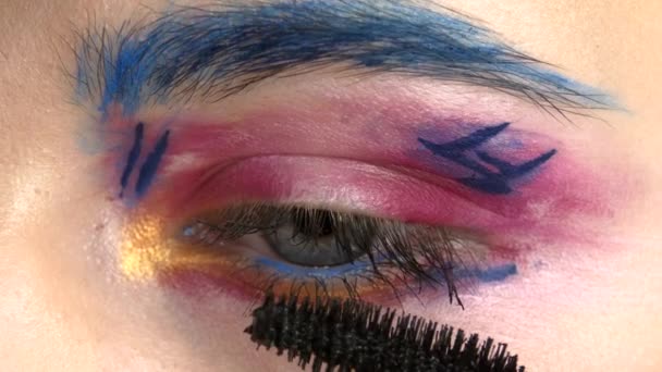 Eye Down Make-up Frau Lidschatten auftragen, exotisch machen, eine, blaue Augenbraue, gelber Schatten, Wimperntusche, letzte Berührung, Nahaufnahme, auf weiß — Stockvideo