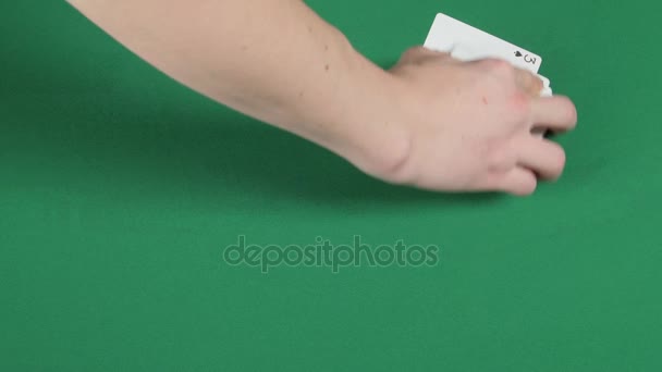 Playing cards being spread round on a green surface by magician — Stock Video