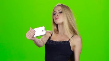 Selfie yapıyor smartphone kamera sarışın kız. Yeşil ekran
