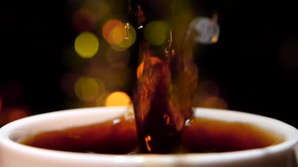 In cup of espresso falls piece of sugar. Slow motion — Stock Video