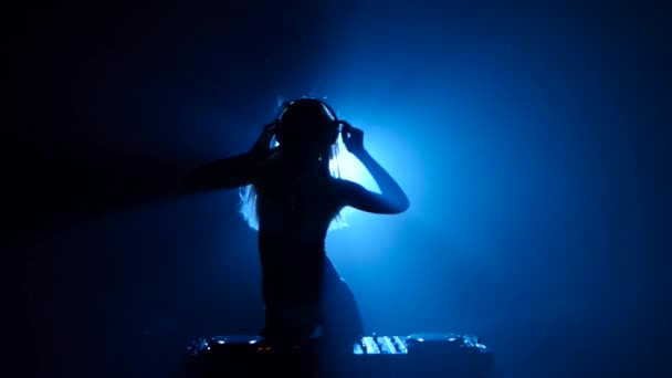 Model girl dj plays track and erotically dancing in silhouette — Stock Video