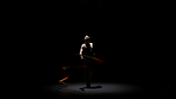 Flexible gymnast with tape creates beautiful hands graceful movements. Black background — Stock Video