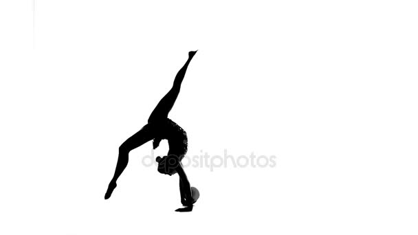 Gymnast with the ball in his hands flips forward. White background. Silhouette. Slow motion — Stock Video