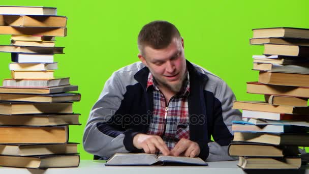 Kille som är roligt läsa och bläddrade igenom boken. Grön skärm — Stockvideo