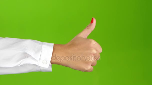 Zeichensprache. Hand zeigt Daumen nach oben auf grünem Hintergrund