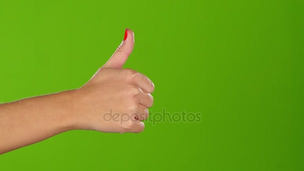 Thumb up girl shows twice per frame. Greeen screen. Closeup — Stock Video