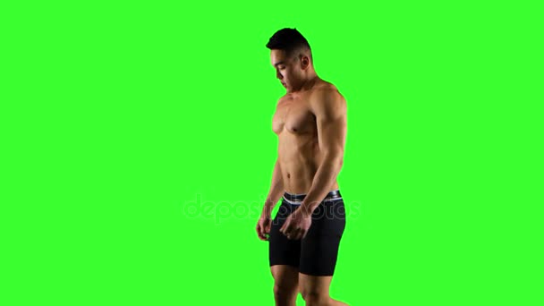 Sportsman walks and runs on a treadmill. Green screen studio — Stock Video