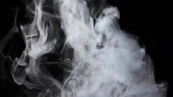 Intense flow of white fog streams from bottom, black background — Stock Video
