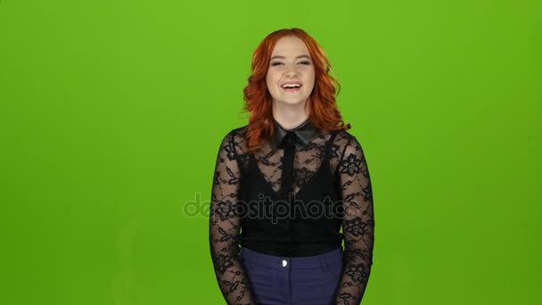 Redhaired girl smiles, laughs, is happy and cheerful. Green screen — Stock Video