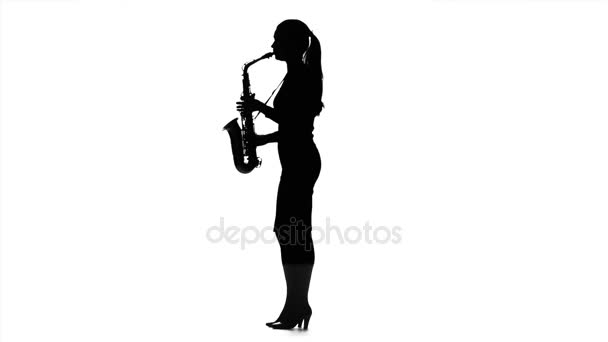 Musician woman playing on saxophone. Black silhouette in slow motion — Stock Video