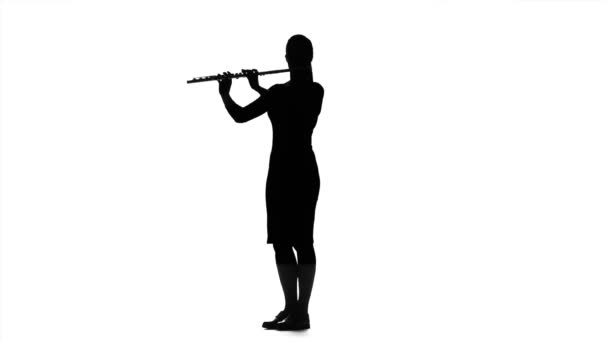 Musician girl playing on flute in slow motion. White studio — Stock Video