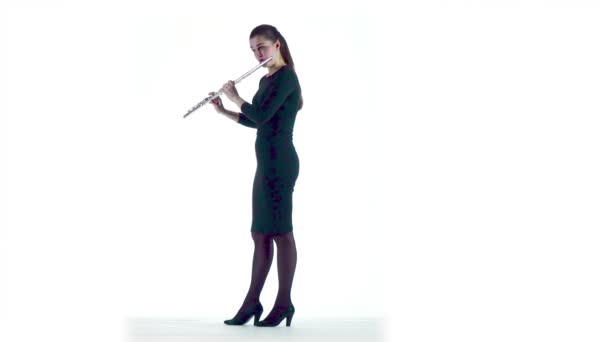 Kvinna spelar flöjt melodi i slow motion. Vita studio — Stockvideo