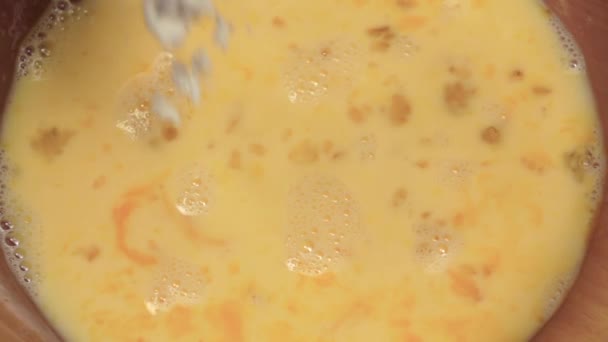 Flour added to plate with liquid batter. Slow motion, closeup — Stock Video