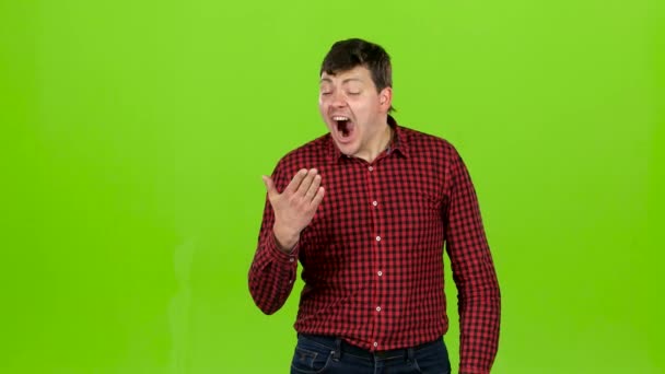 Sleeps a man, yawns, he is sleepy and wants to go to bed. Green screen — Stock Video