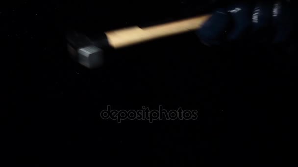 Brings a hammer to the glass and hits it, it crumbles into small pieces. Black background. Slow motion — Stock Video