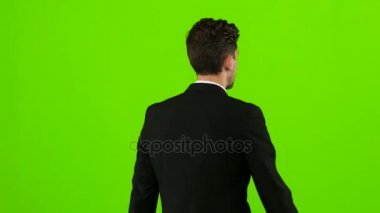 Adam bir iş toplantısına gidiyor ve selamlar sallayarak. Yeşil ekran. Arkadan Görünüm