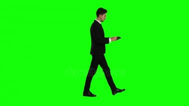 Adam işe gider ve bir dizüstü bilgisayar tutar ve resimlere görünüyor. Yeşil ekran