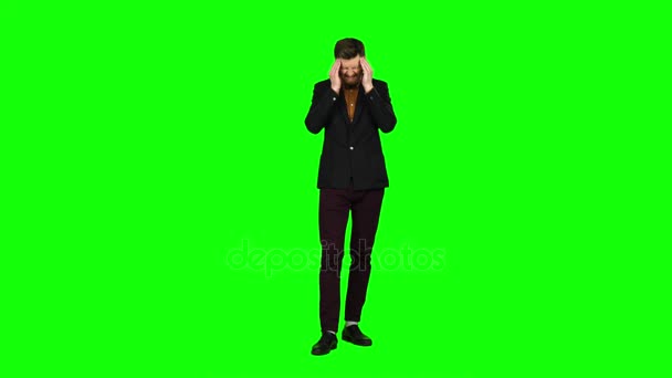 Guy is suffering, his head hurts, he is tired. Green screen — Stock Video