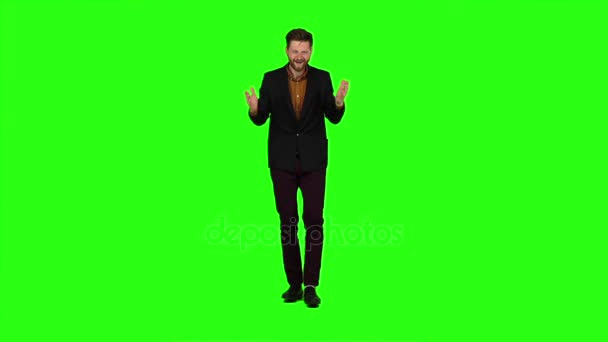 Young guy is happy with his victories, he is happy. Green screen. Slow motion — Stock Video