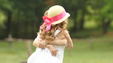 Küçük çocuk kız onun kollarında yapsın ve onlar kadar parkta dön. Ağır çekim