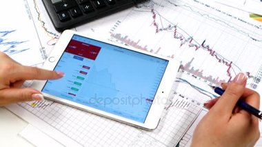 Tablet ile online hisse senedi piyasasında çalışan kadın elinde