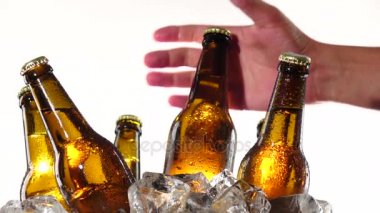 El bir şişe soğuk bira alır. Beyaz arka plan. Yakın çekim