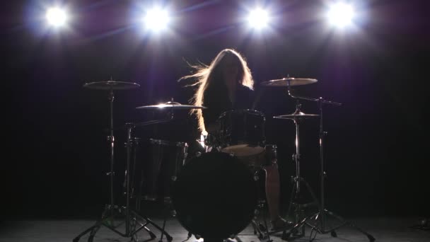 Drummer comes off at a rock concert. Black smoke background. Silhouette — Stock Video