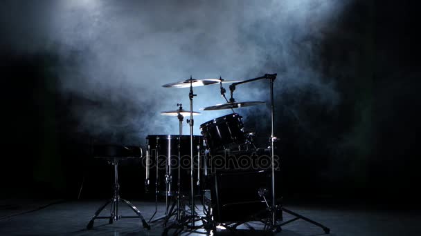 Set of drums, cymbals and other percussion instruments. Black smoky background.