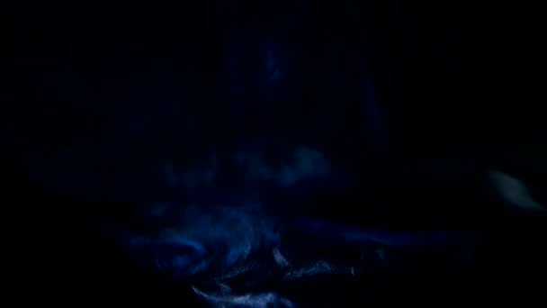 Smoke and blue light from cinema projector. Closeup, black background — Stock Video
