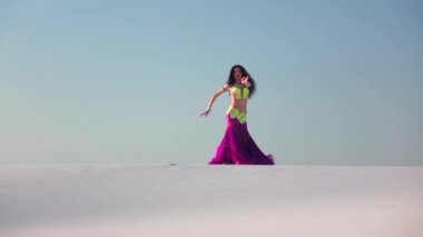 Zarif dansçı karşı parlak bir kıyafetle oryantal dans gökyüzü. Ağır çekim