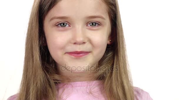 Child genuinely smile at the camera. White background. Close up. Slow motion — Stock Video