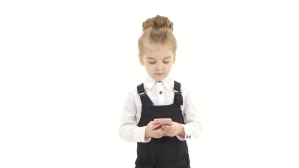 Serious little business girl communicates online in chat on smartphone — Stock Video